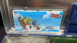 The Legend of Zelda: Phantom Hourglass LUNCHBOX w/ Accessories [NO GAME] (Nintendo DS) Pre-Owned w/ Carrying Case, Headphones, Green Stylus, Grey Stylus, 2 Blue Silicon Cartridge Protectors, and System Decals (As Pictured)