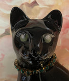 Fenton Art Glass / Stylized Sitting Cat / Approx. 5"/ Black Glass, Green Rhinestone Collar, Yellow(?) Eyes / 1985-1996 Fenton Label / Stamped with Fenton Logo in Glass / See Notes / No Original Box (Pre-Owned)